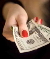 women handing off money